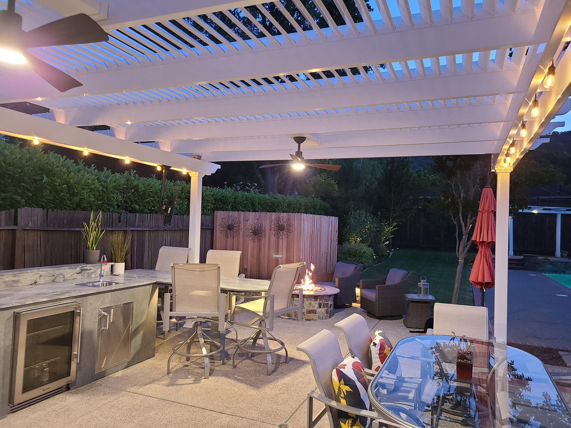 white pergola with double outdoor fans and fan mounts